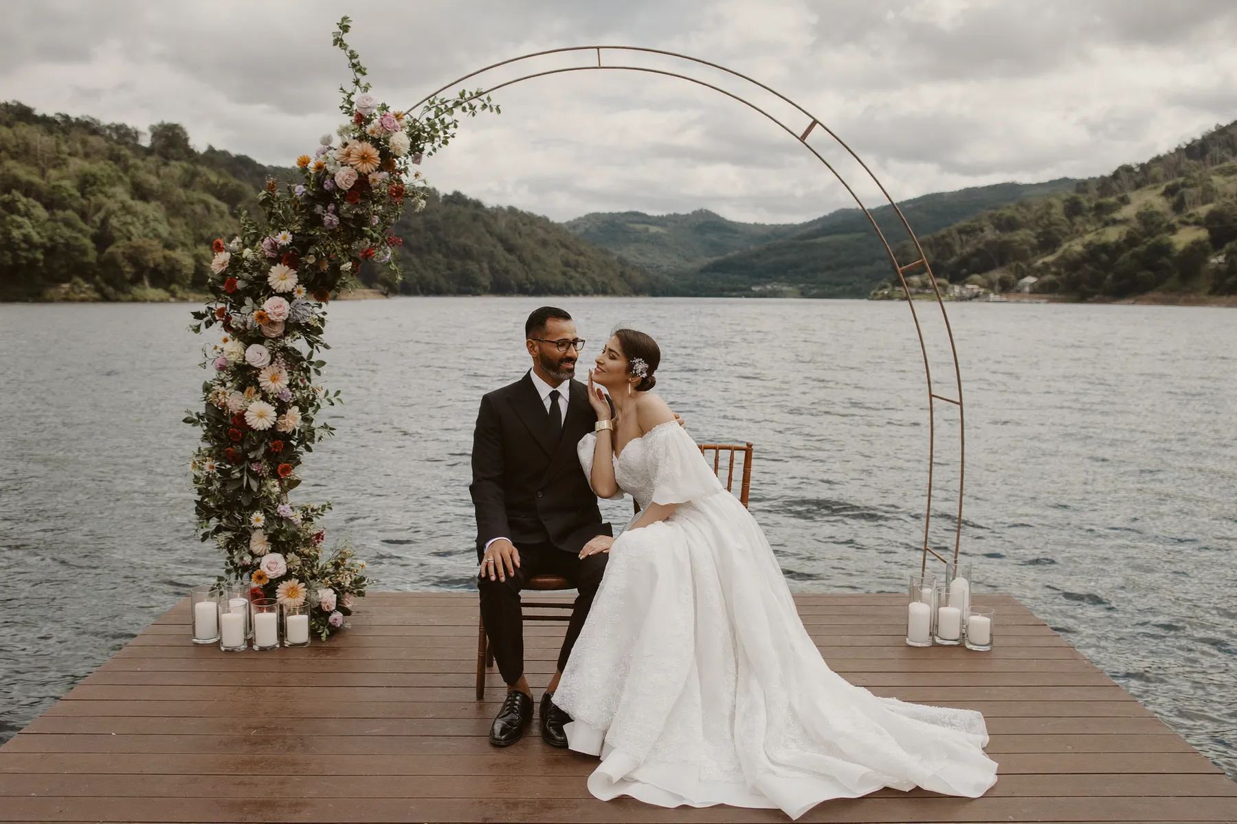 Circular floral arch set on a dock above a lake in Killarney