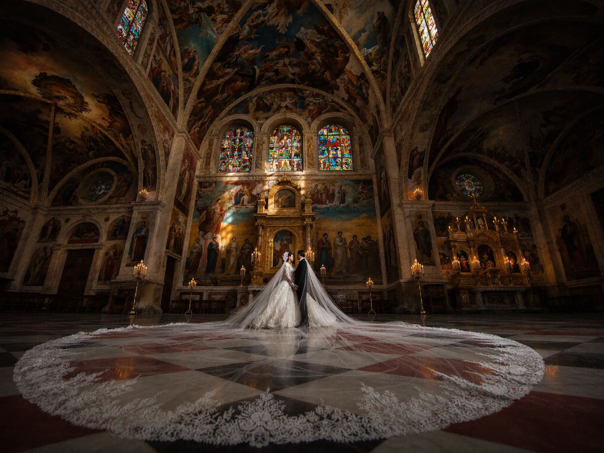 Bride and her cathedral train laid out on the tiled floor of a domed church