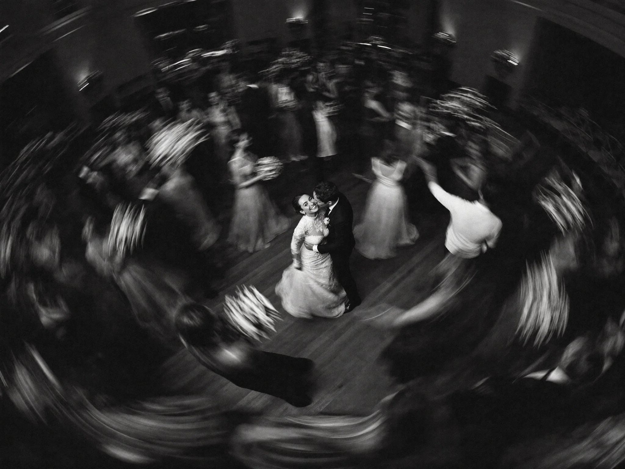 Spinning motion blur of a couple's first dance seen from above