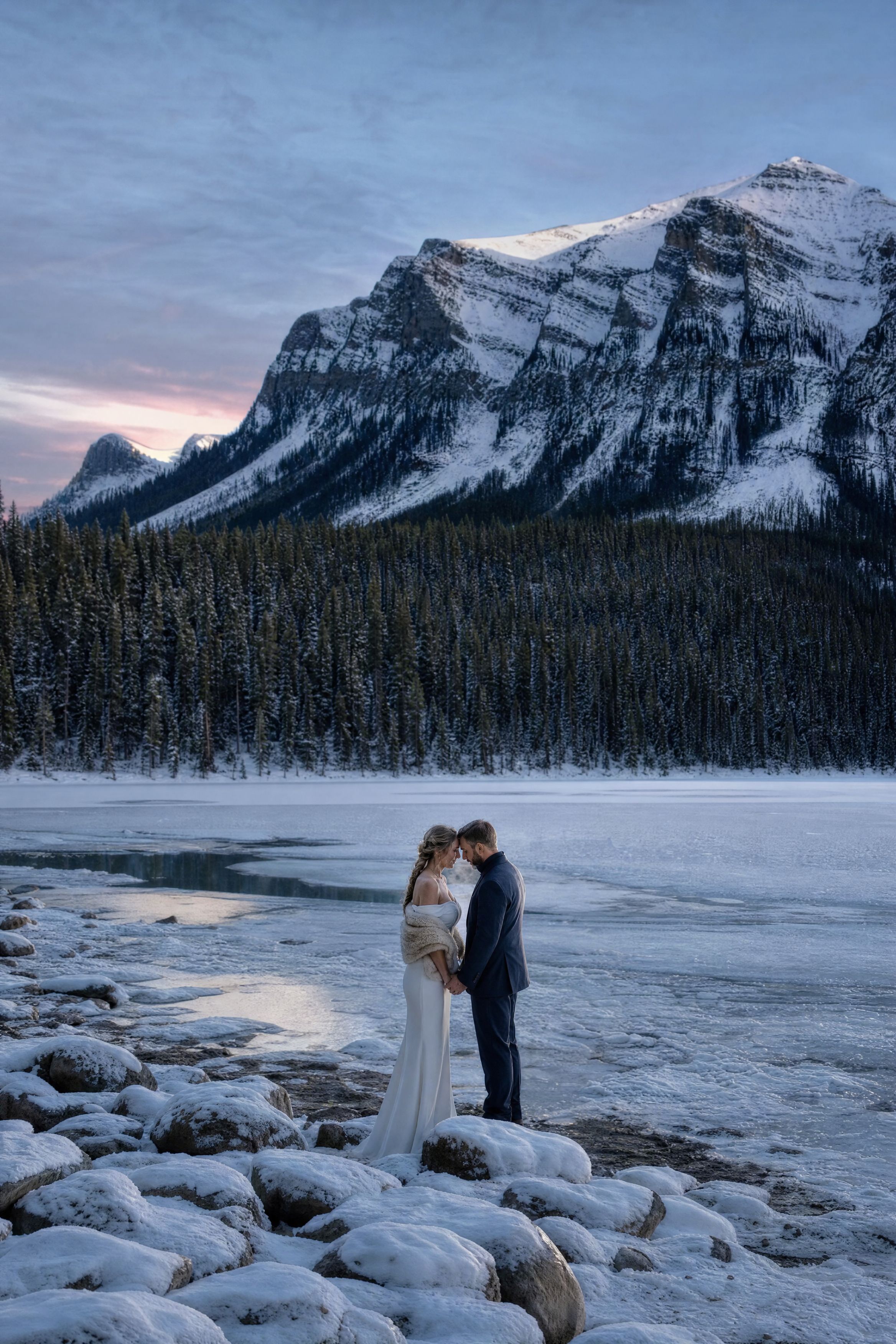 A couple in the foothills outside Banff with the range on the horizon