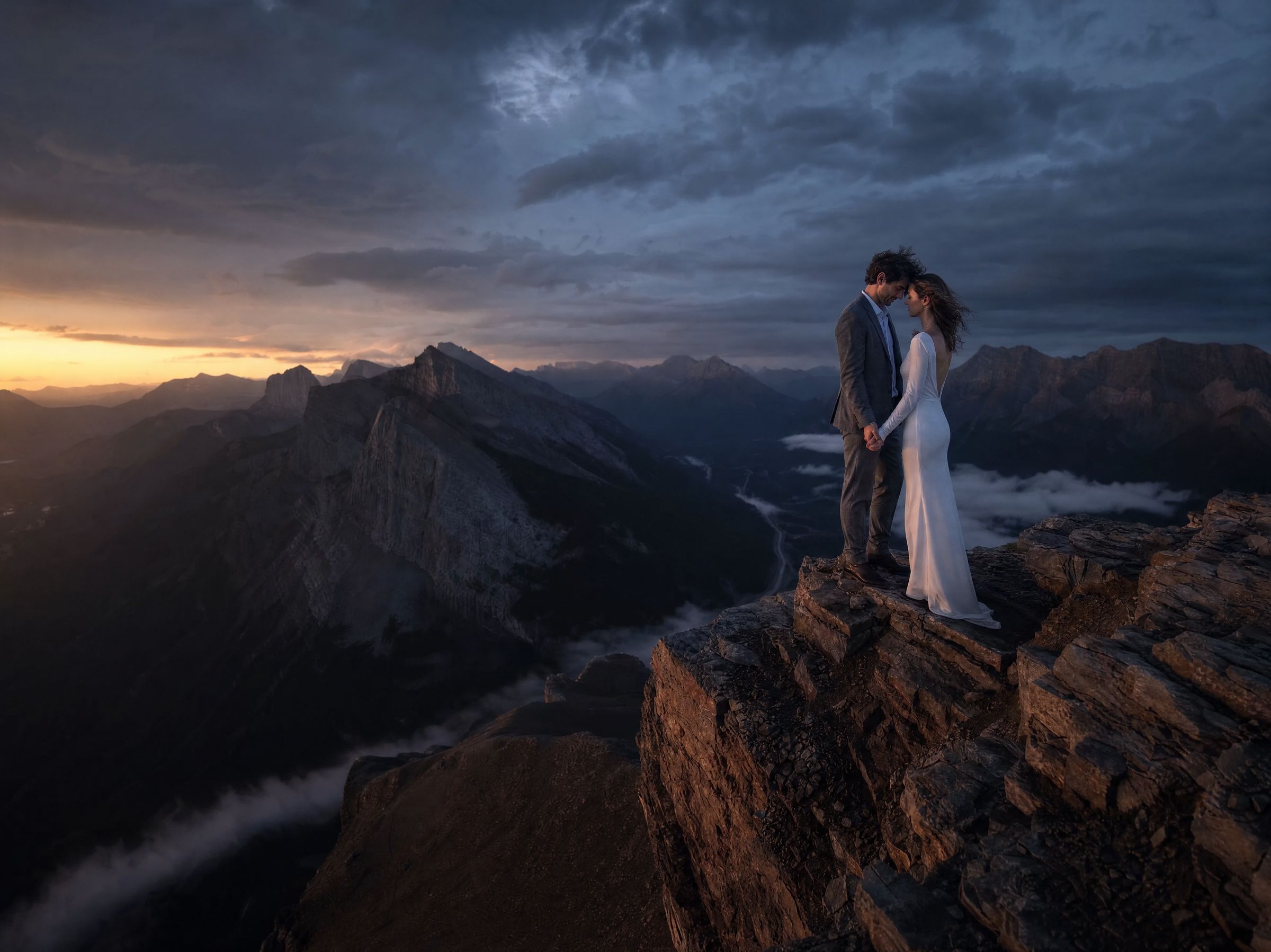 A couple on a ridge at last light in the Canadian Rockies