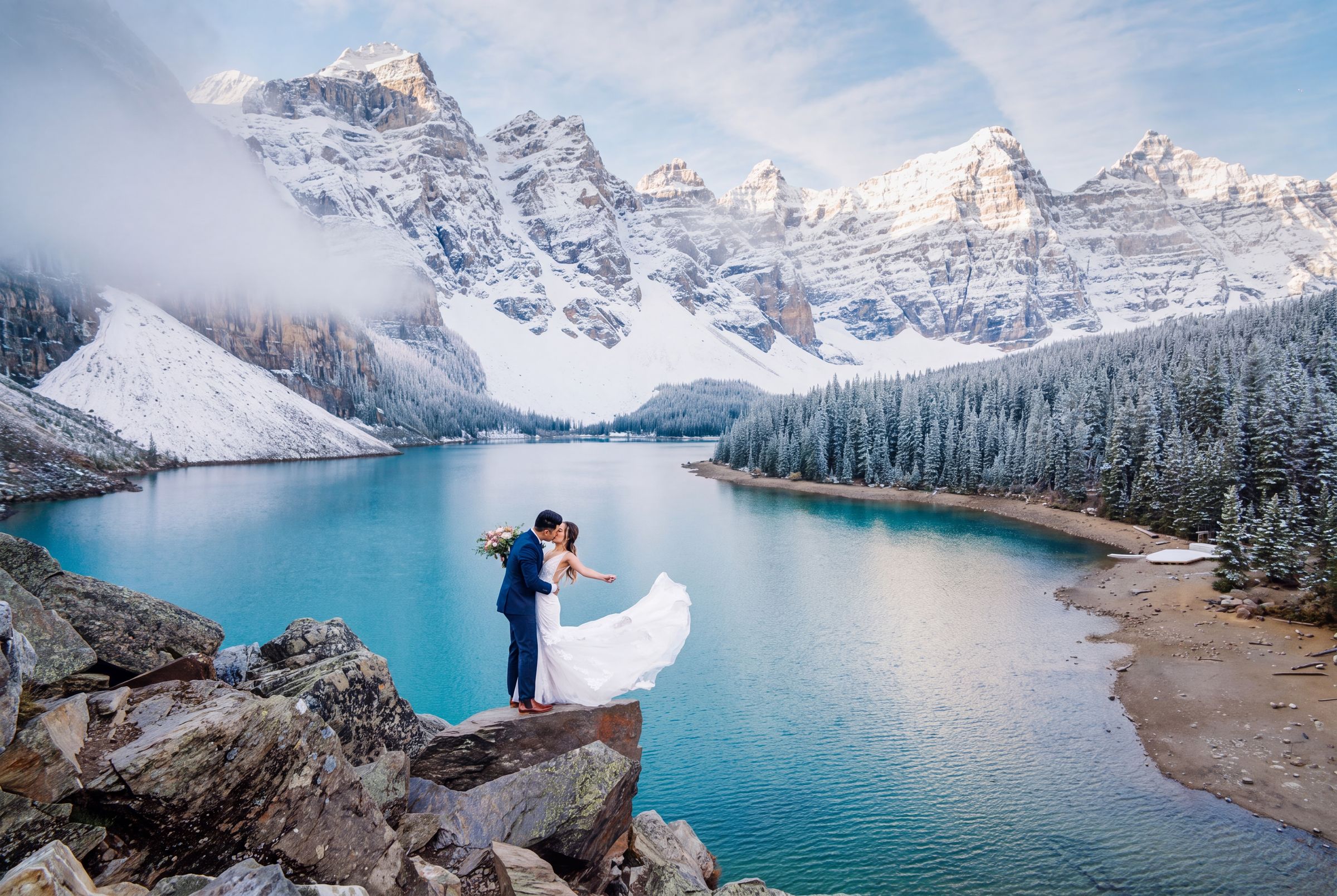 A turquoise lake below snow-covered peaks in the Canadian Rockies