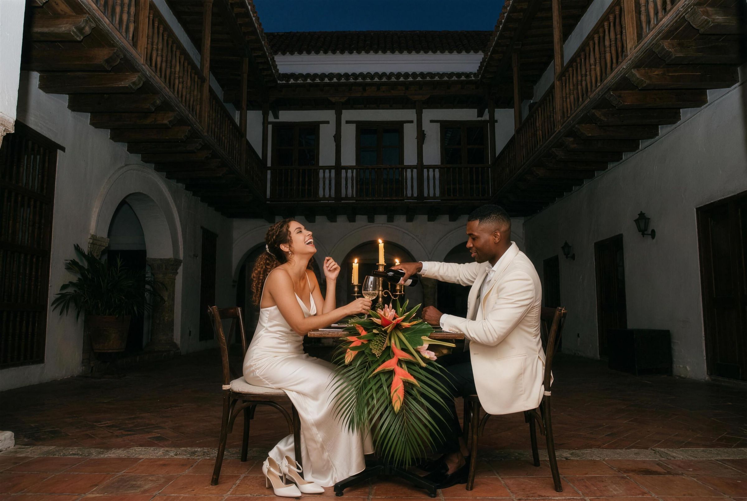A candlelit table in a colonial courtyard in Cartagena at night