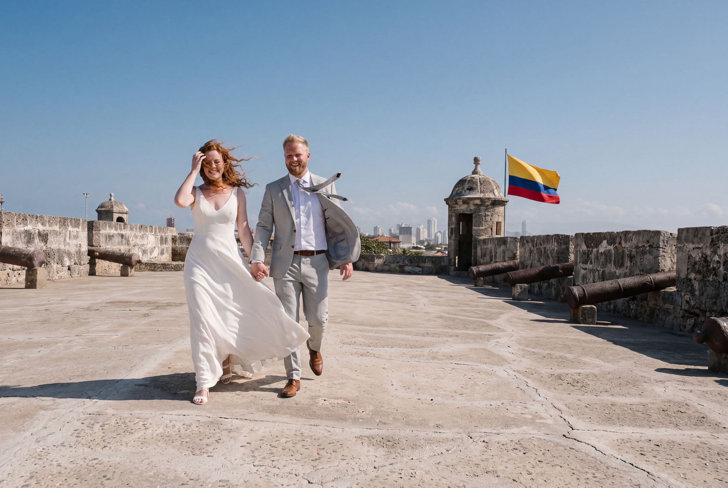 A couple sharing an umbrella on a rainy lamplit street in the walled city of Cartagena