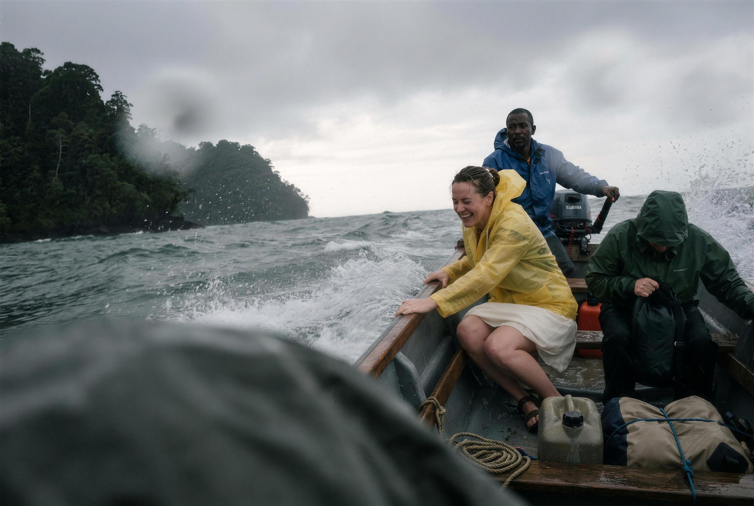 A small boat crossing choppy grey water off the Chocó coast with the crew in rain gear