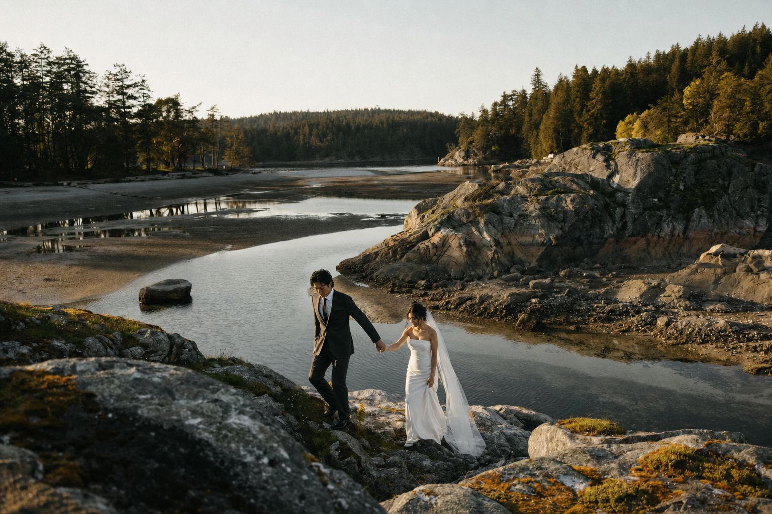 A couple walking through old-growth forest in the late afternoon on Vancouver Island
