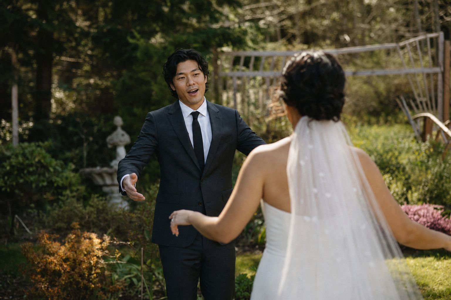 A groom turning to see his bride for the first time in a Vancouver Island garden