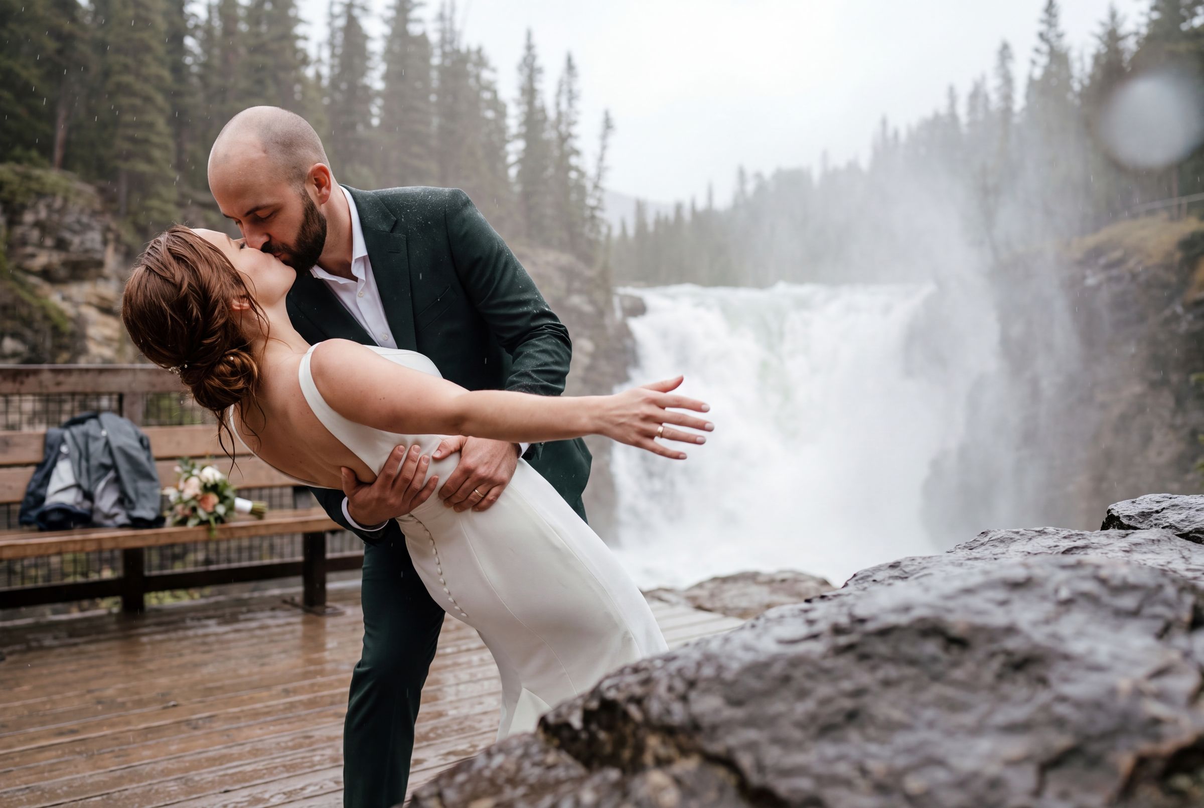 A couple beside a powerful waterfall in Jasper National Park