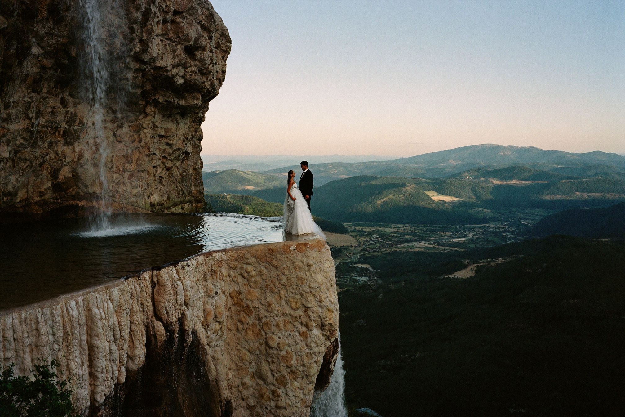 A couple on the mineral terrace at Hierve el Agua above the valley in Oaxaca