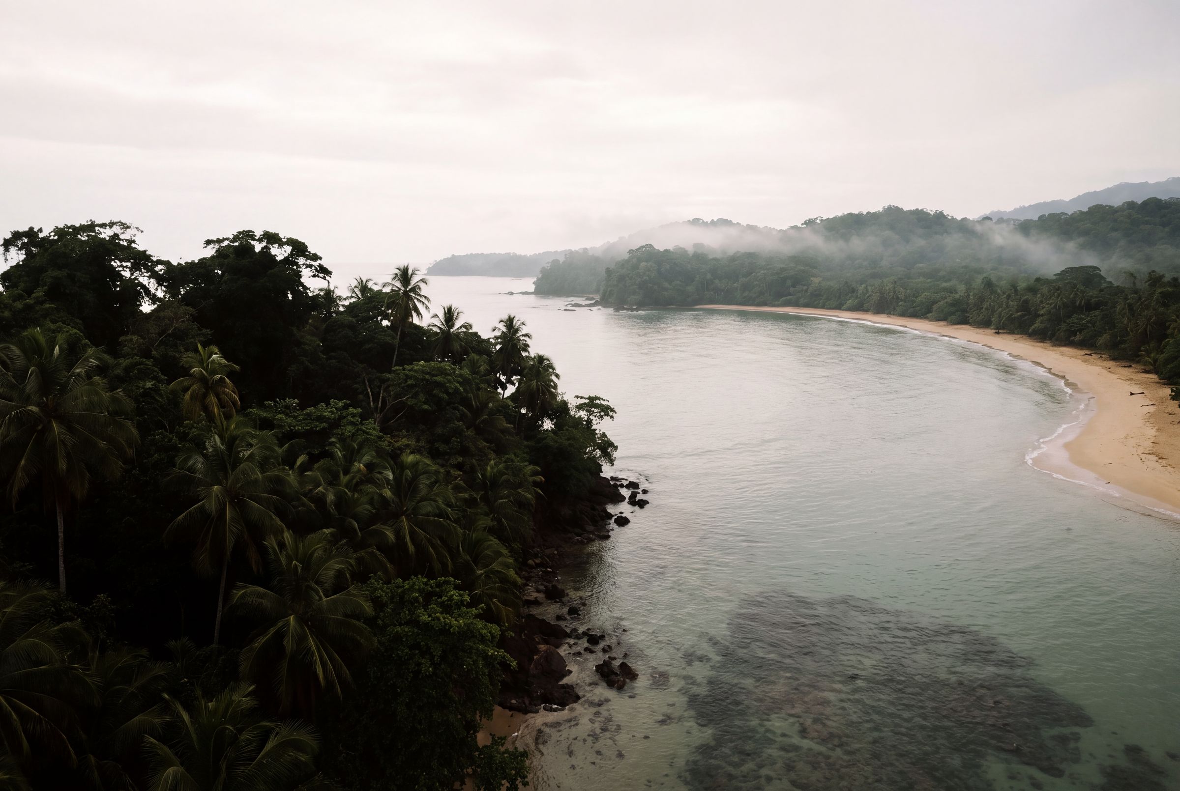 A headland with the water going pale over the reef at Punta Uva