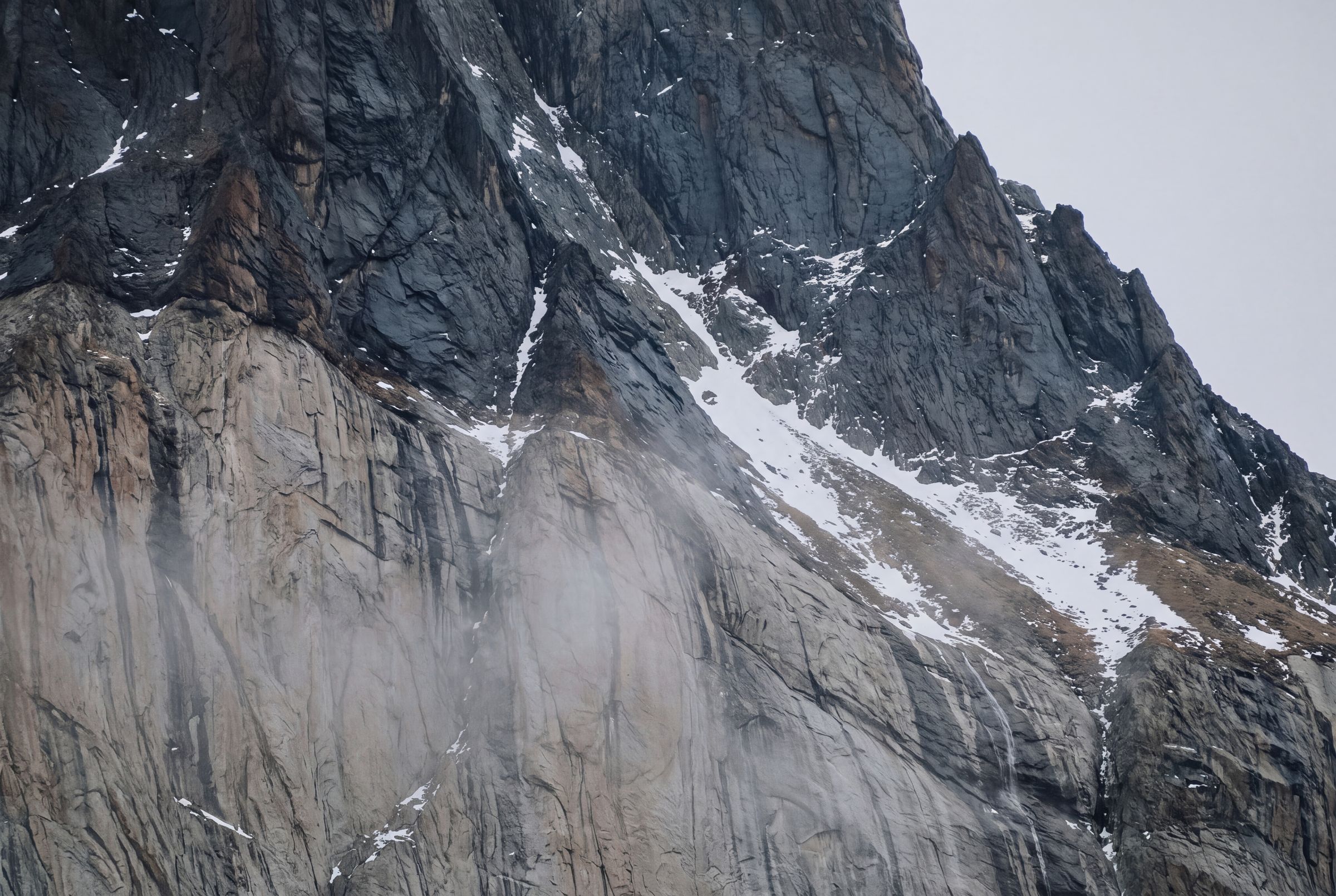 Slate cloud lying low over granite, close in