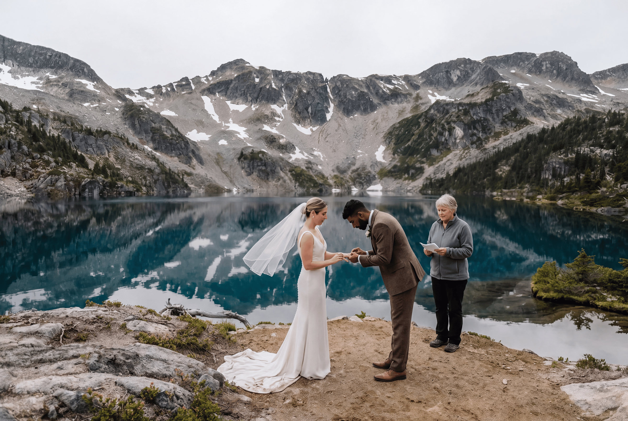 A small ceremony with an officiant beside a turquoise alpine lake near Whistler