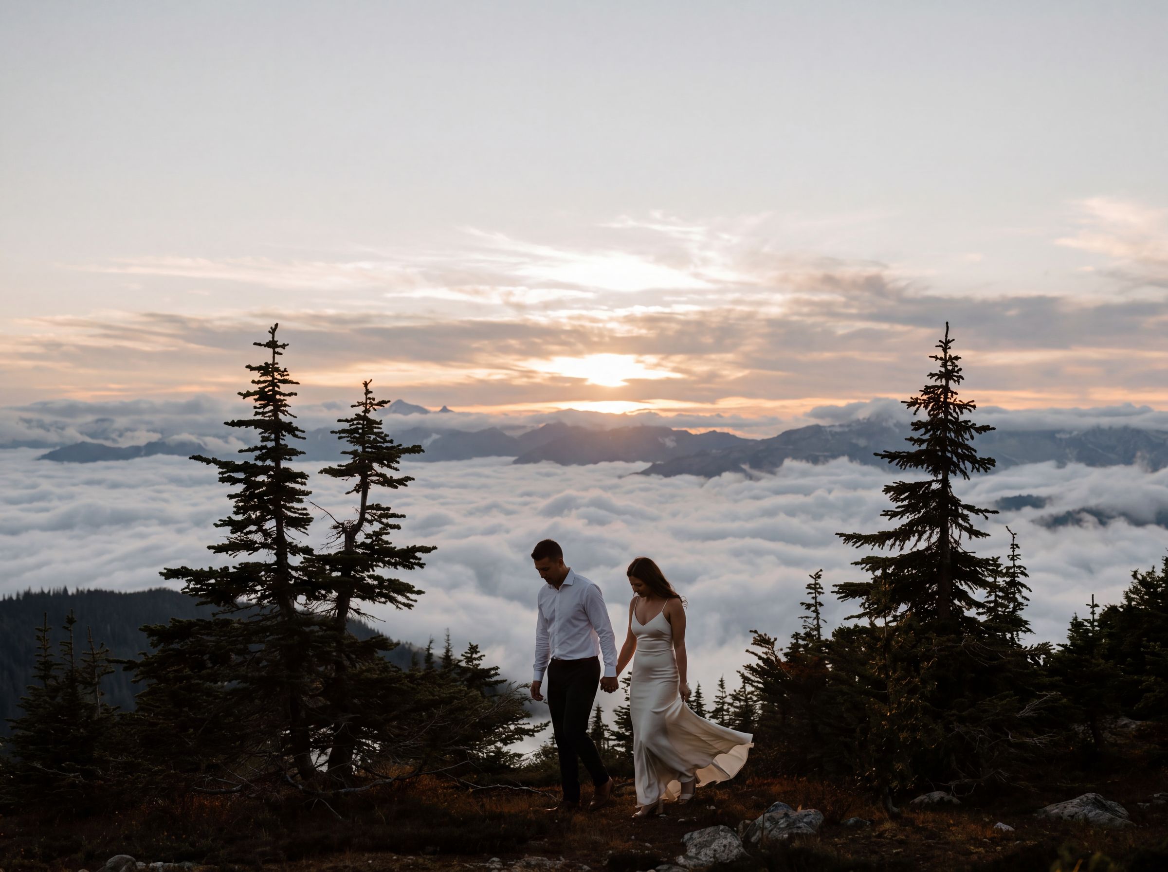 A couple above the clouds at sunset in the mountains around Whistler