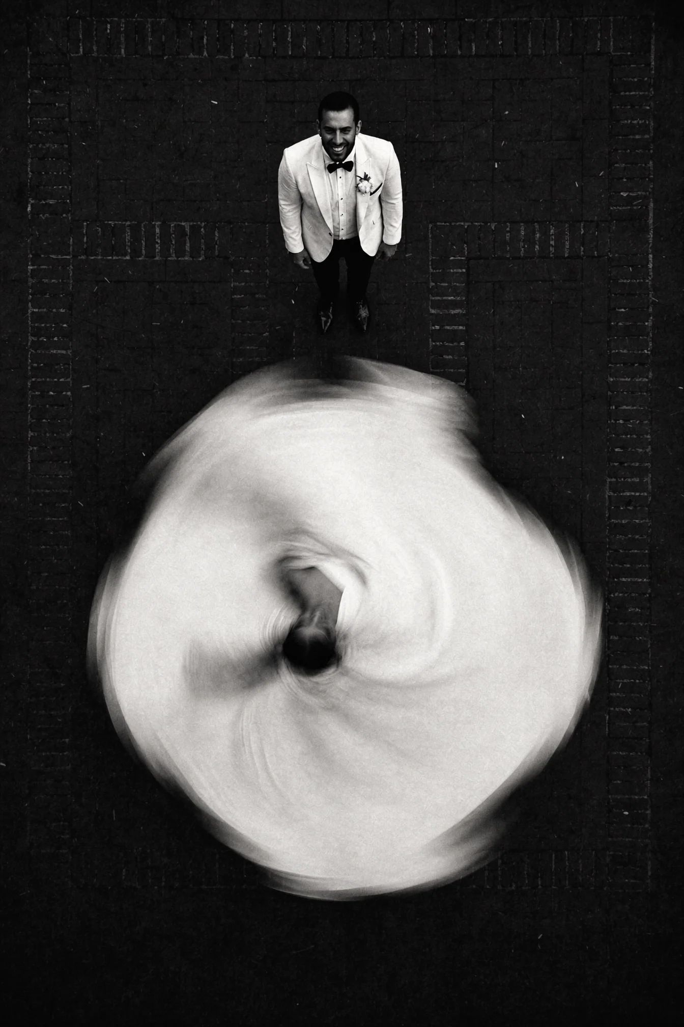 Overhead black and white frame of a spinning dress dissolving into blur