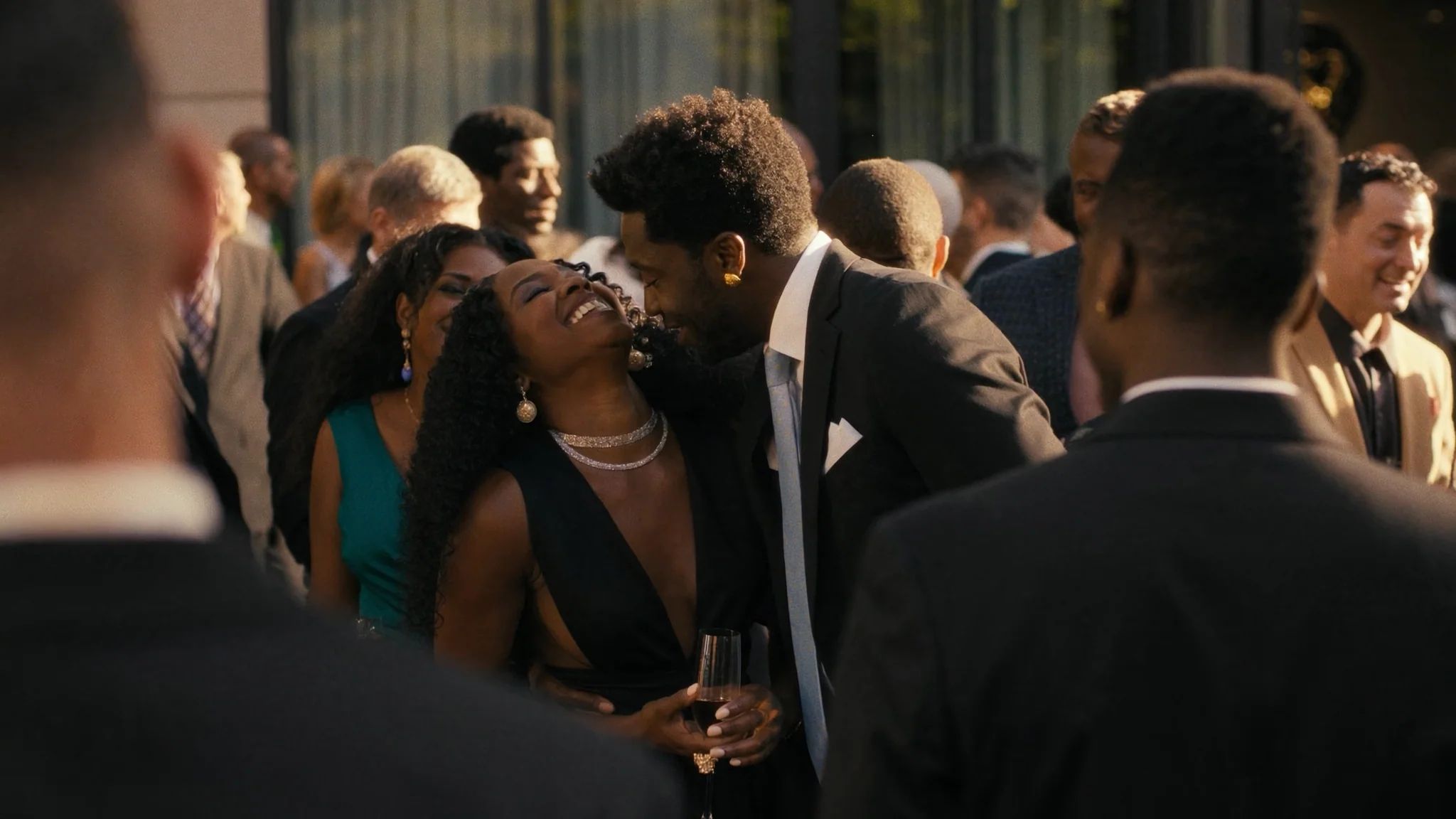 Guests laughing together with champagne at the reception