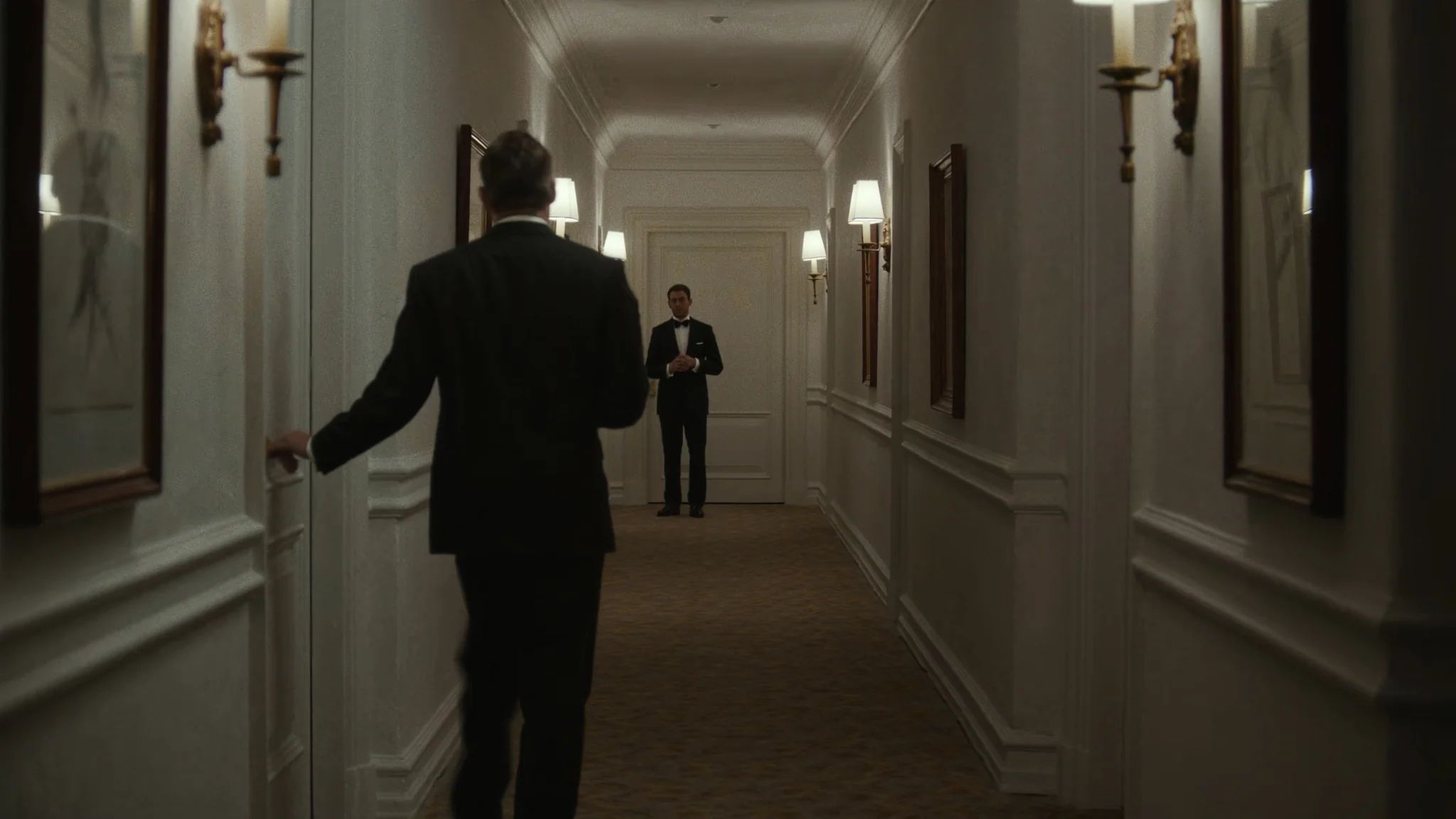 Groom walking away down a hotel corridor