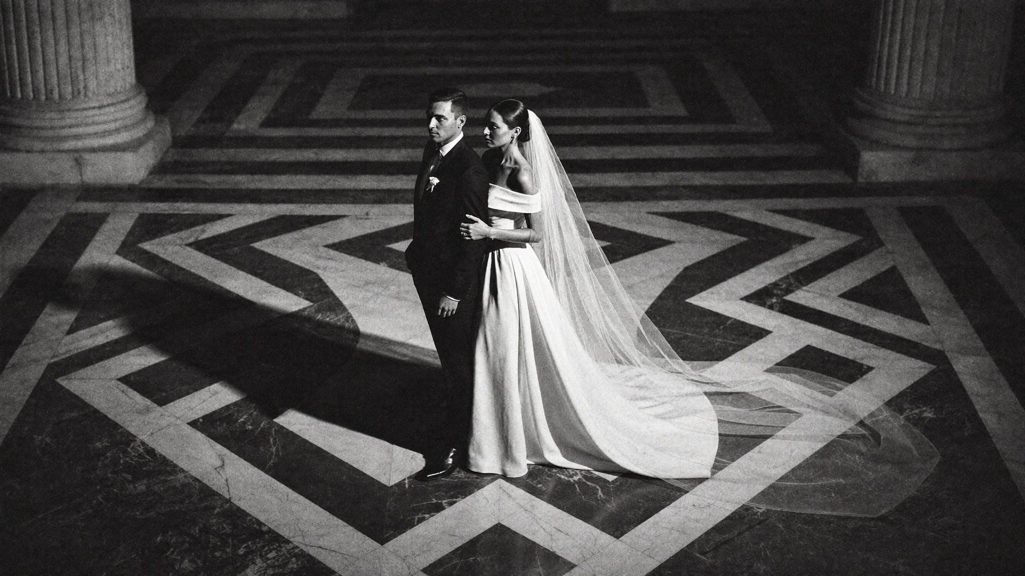Couple centred on a graphic black and white marble floor