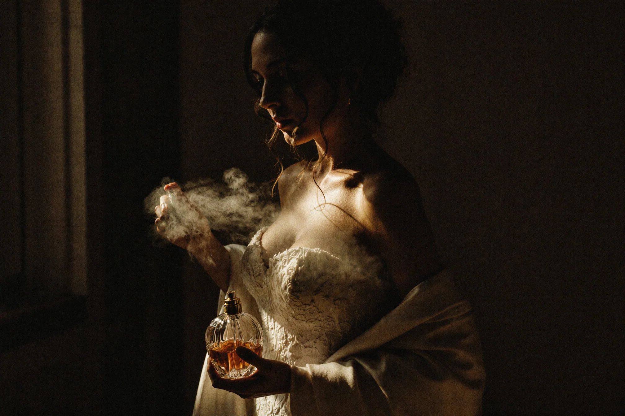 Bride holding a whisky glass in warm low light