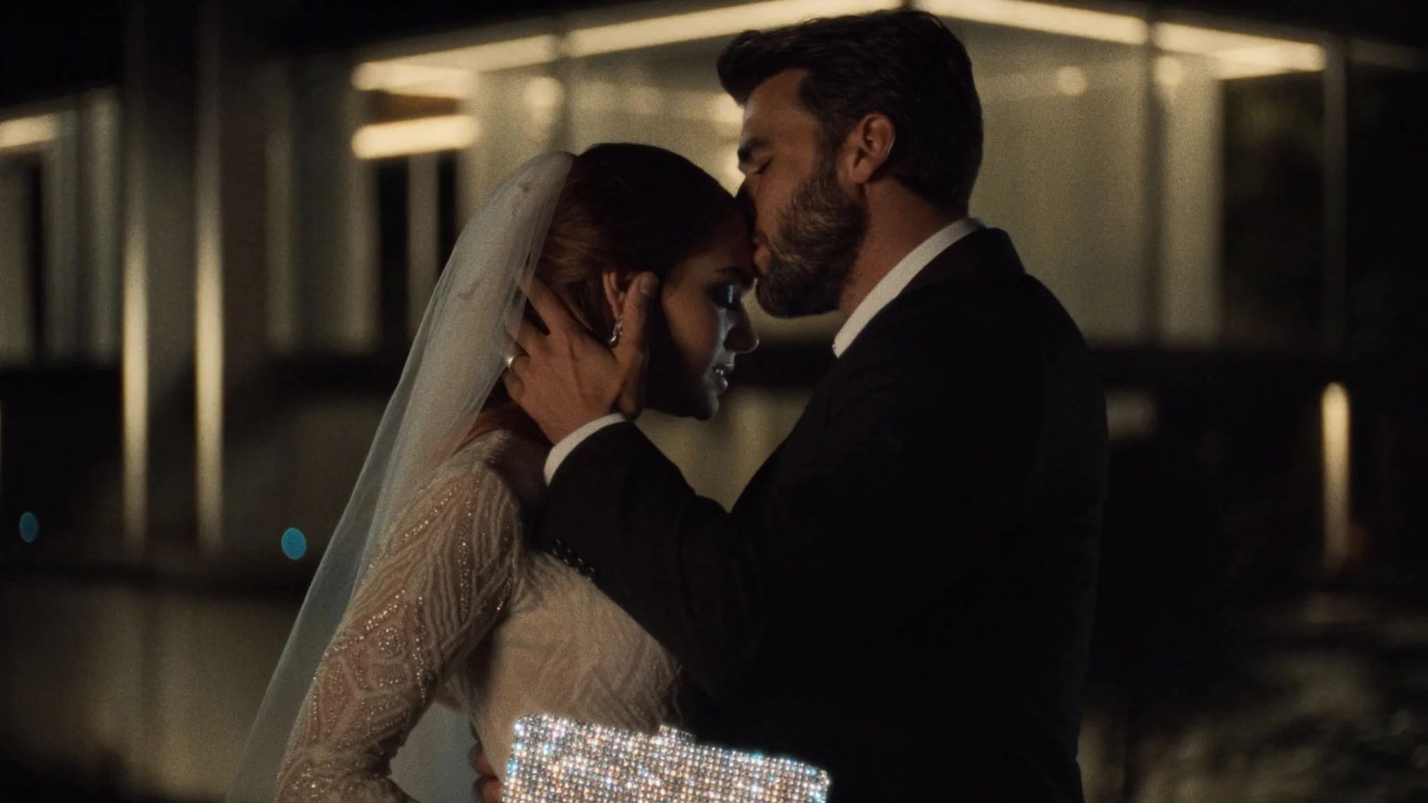 Couple close together in a warmly lit interior