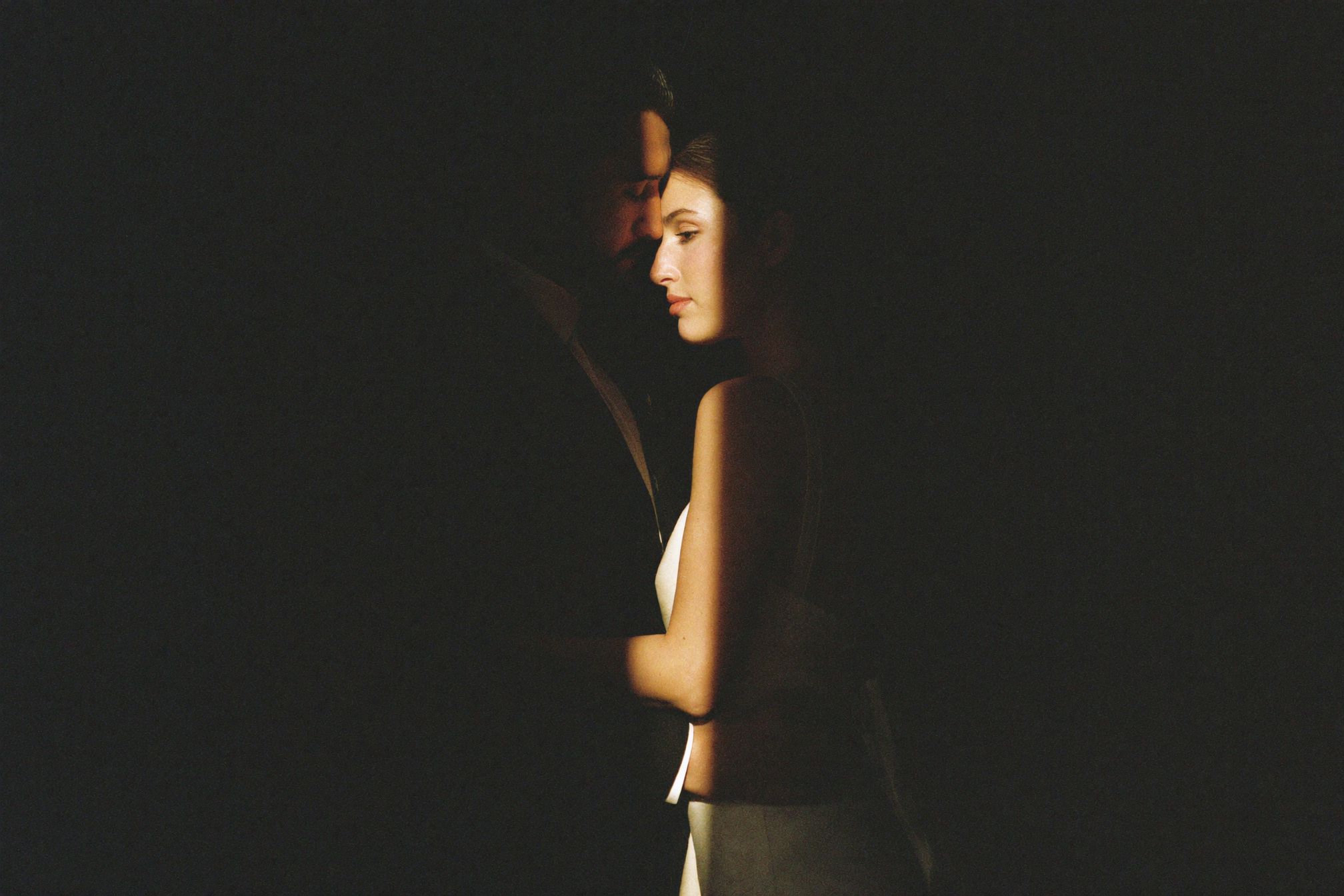 An intimate elopement couple in dramatic low light
