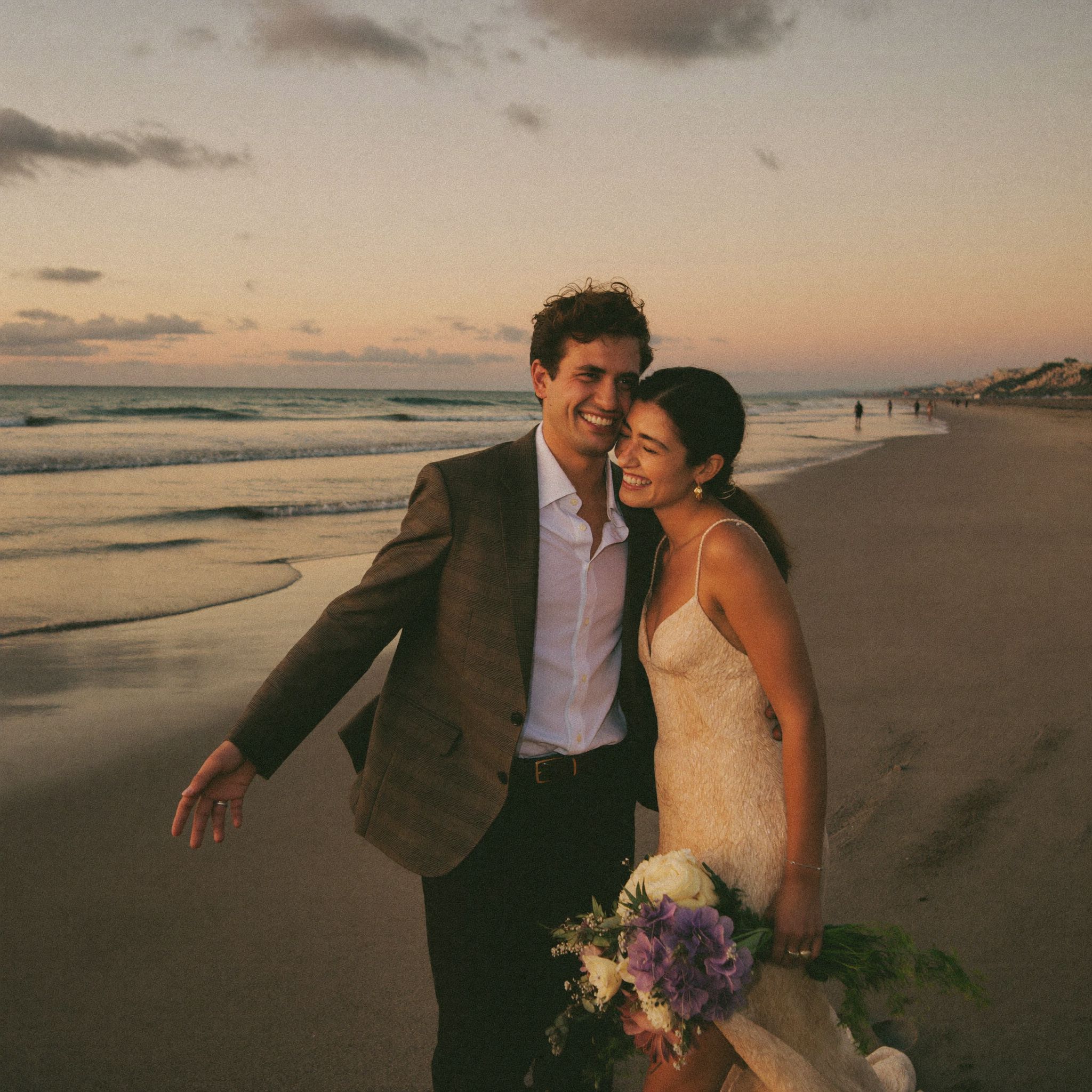 A couple walking the beach in Guanacaste as the light goes