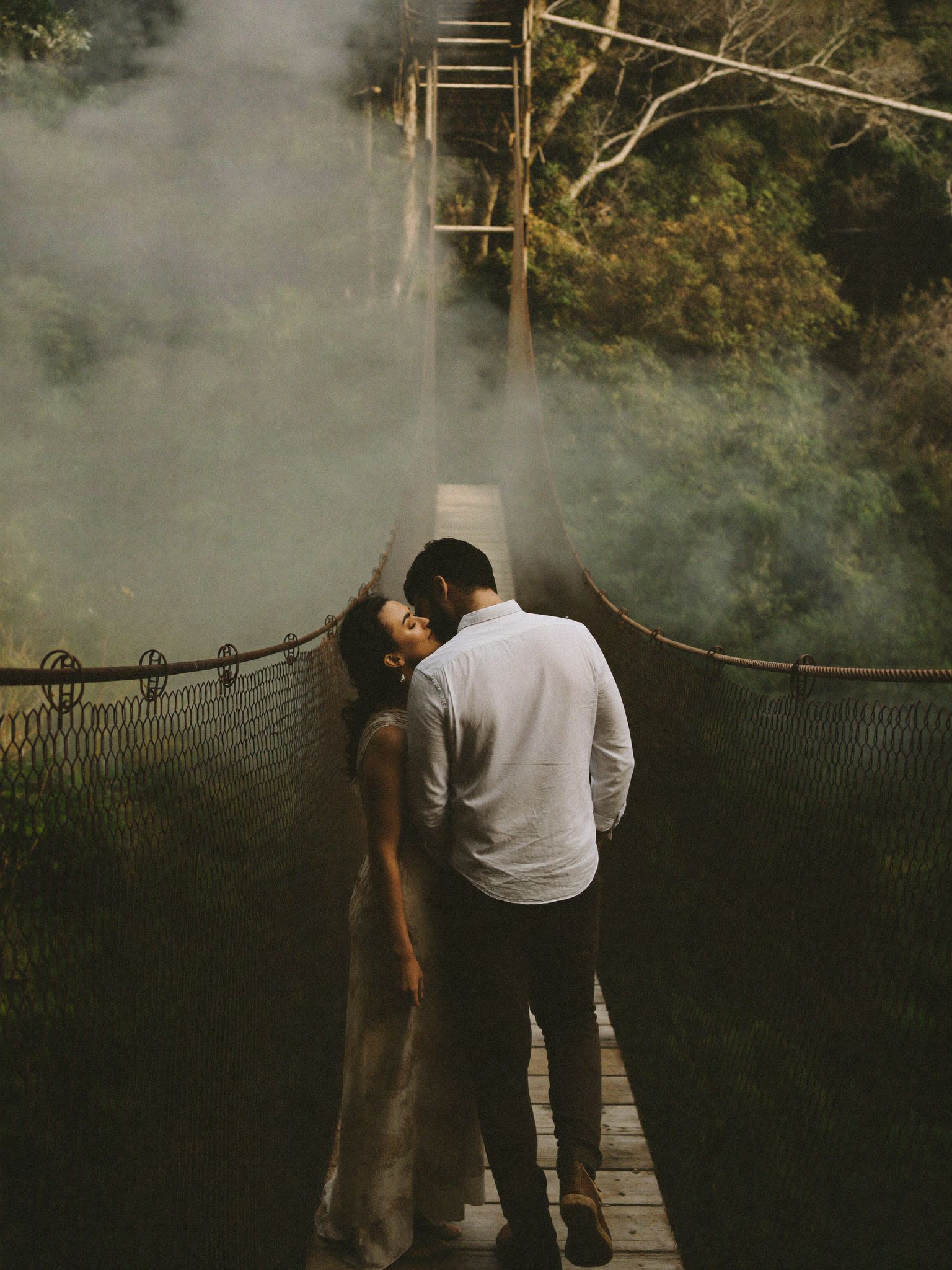 A couple on a walkway above the forest canopy
