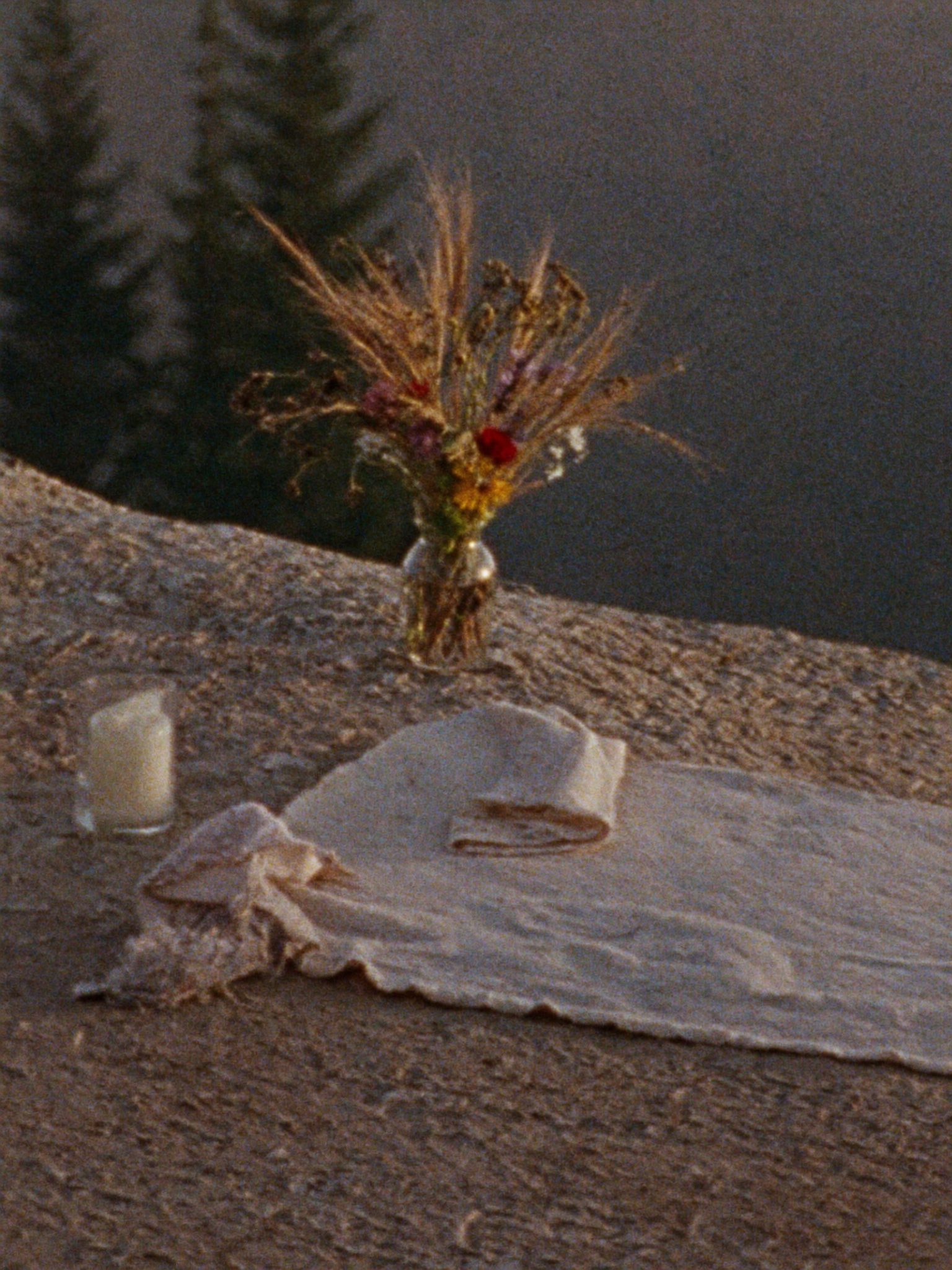 An intimate elopement ceremony set with wildflowers and candles
