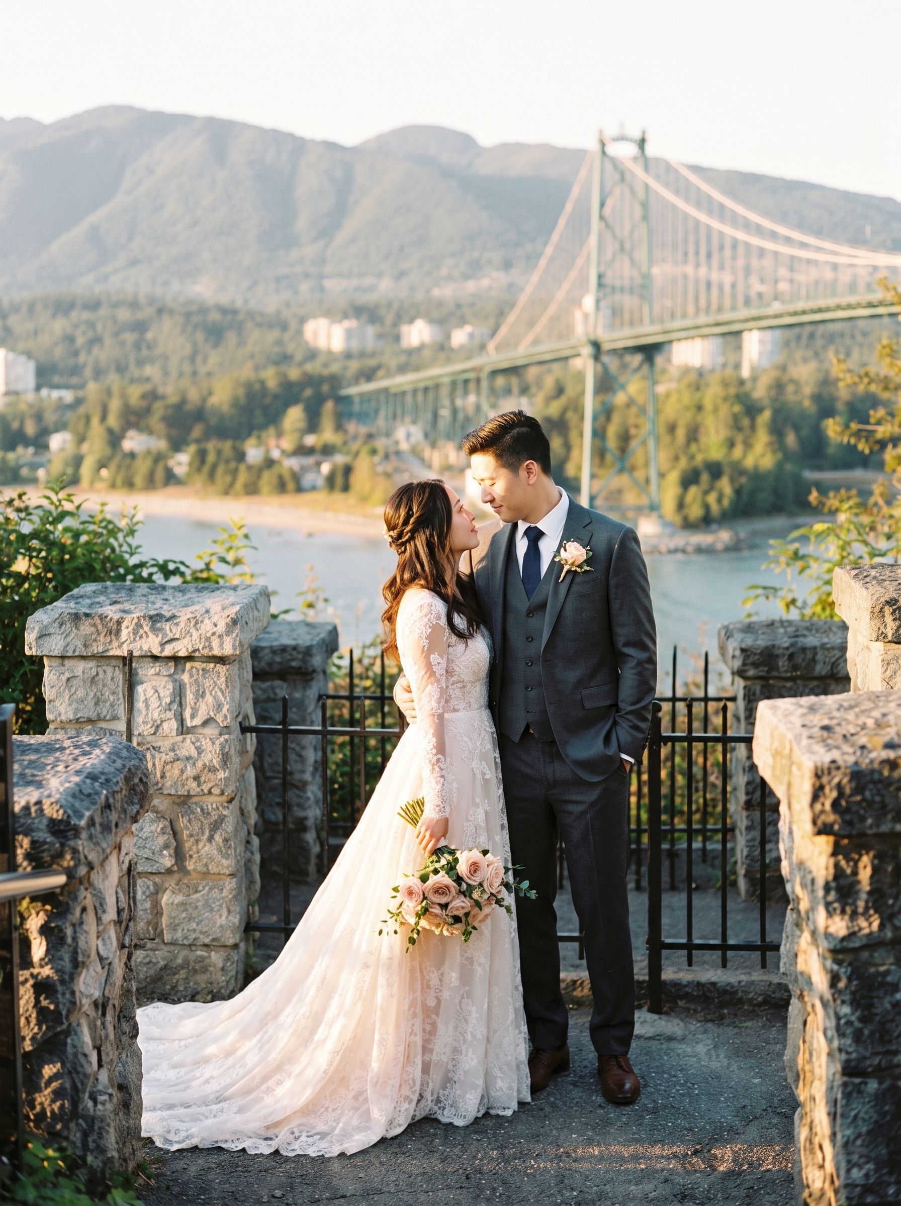 A couple above the Lions Gate Bridge with Vancouver behind them