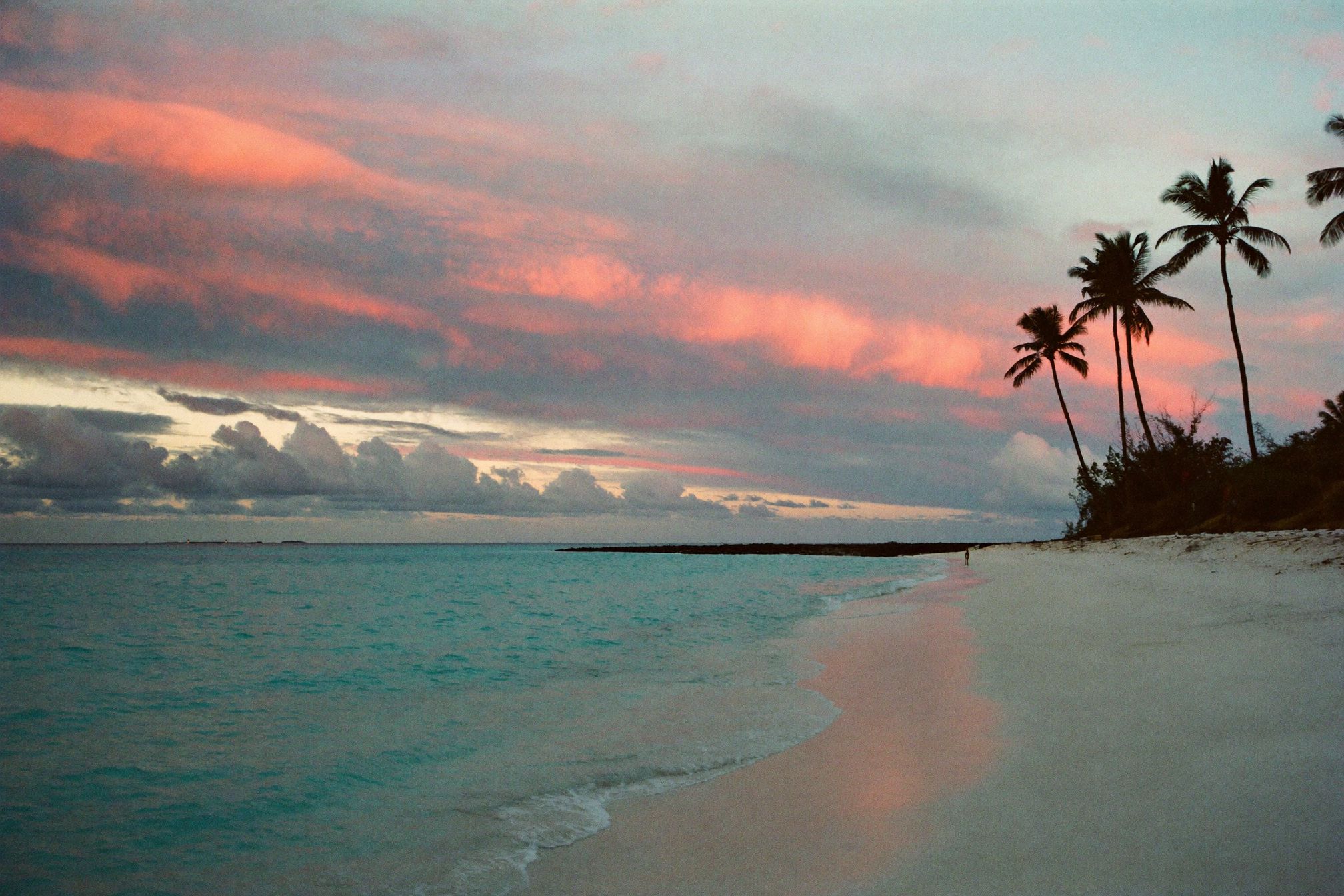 An empty beach at dawn with soft light on the Caribbean