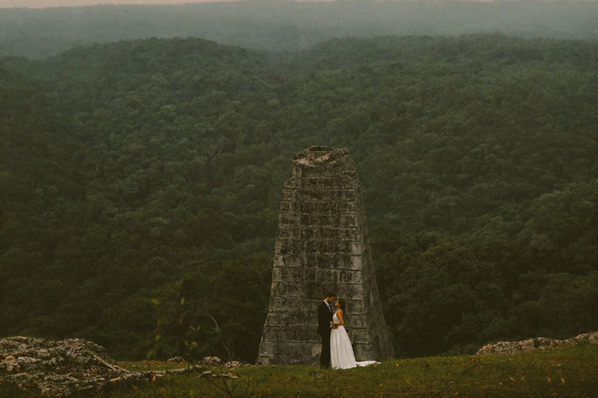 A tall stone pyramid rising out of the jungle canopy