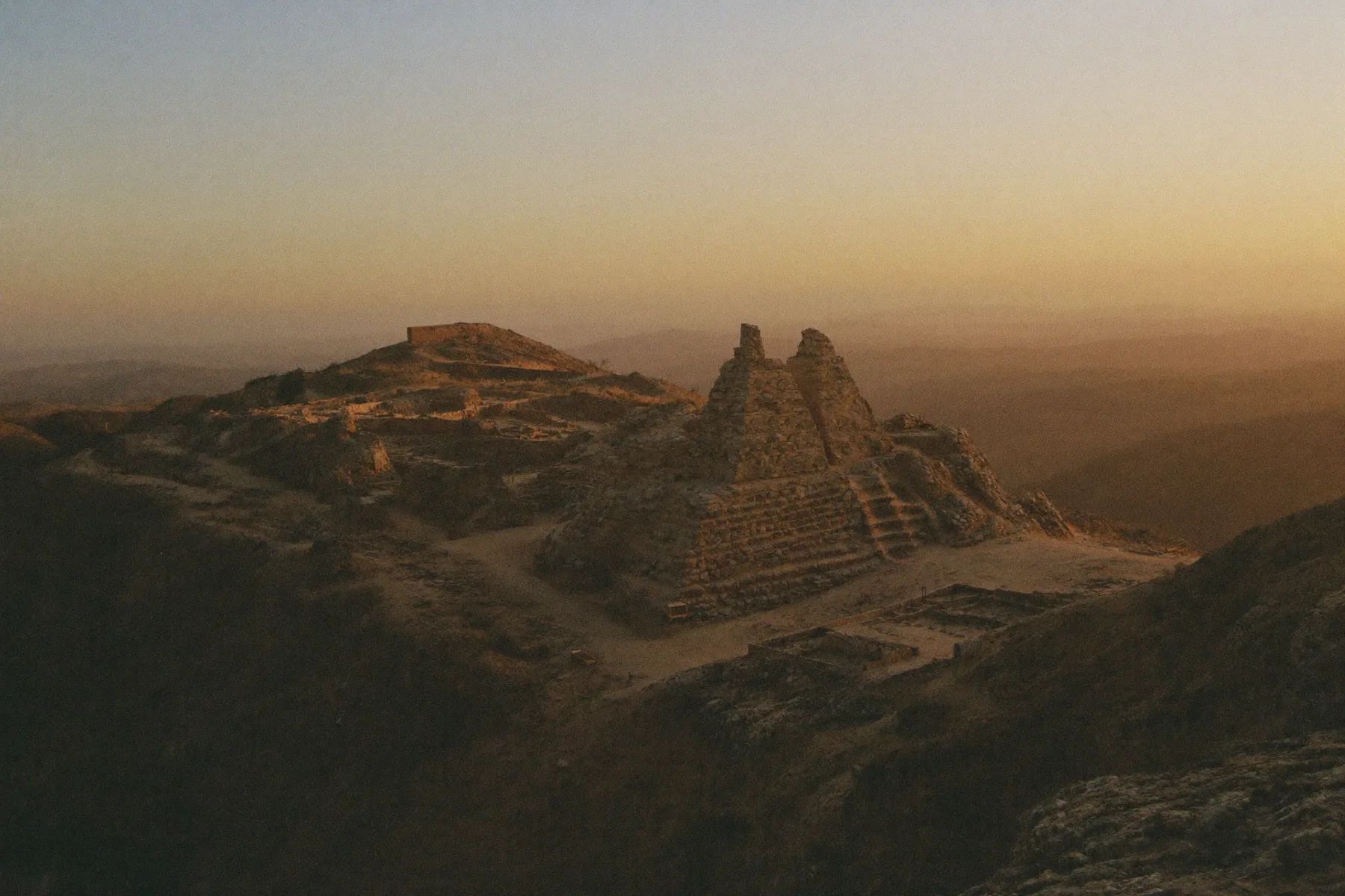 The ruined hilltop complex of Monte Alban above the Oaxaca valley at dusk