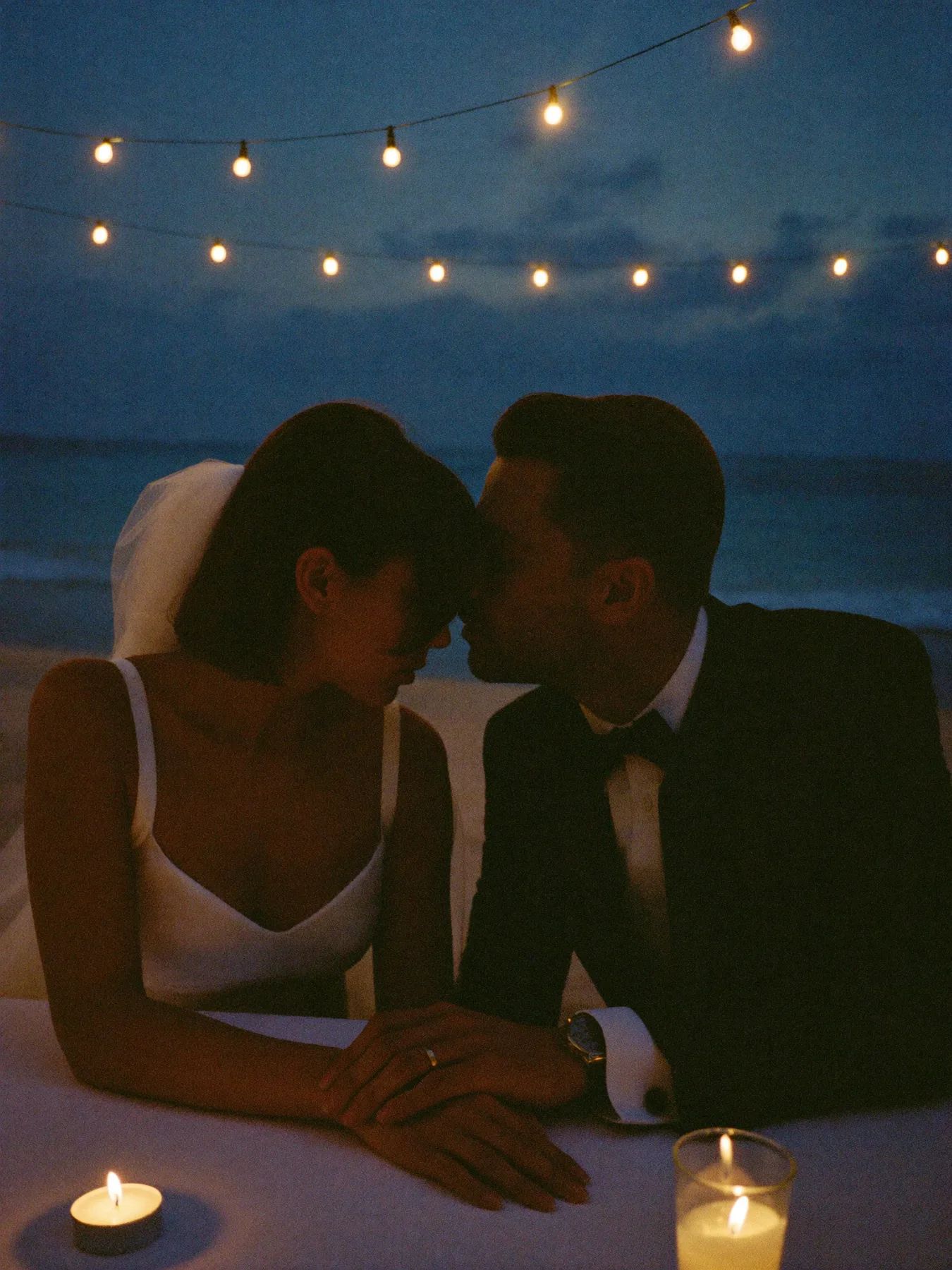 A candlelit table set for two on a Mexican terrace at night