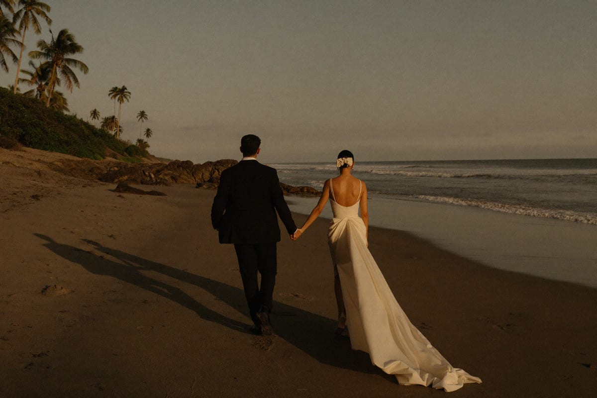 A couple alone on the Costa Rican coast at the end of the day