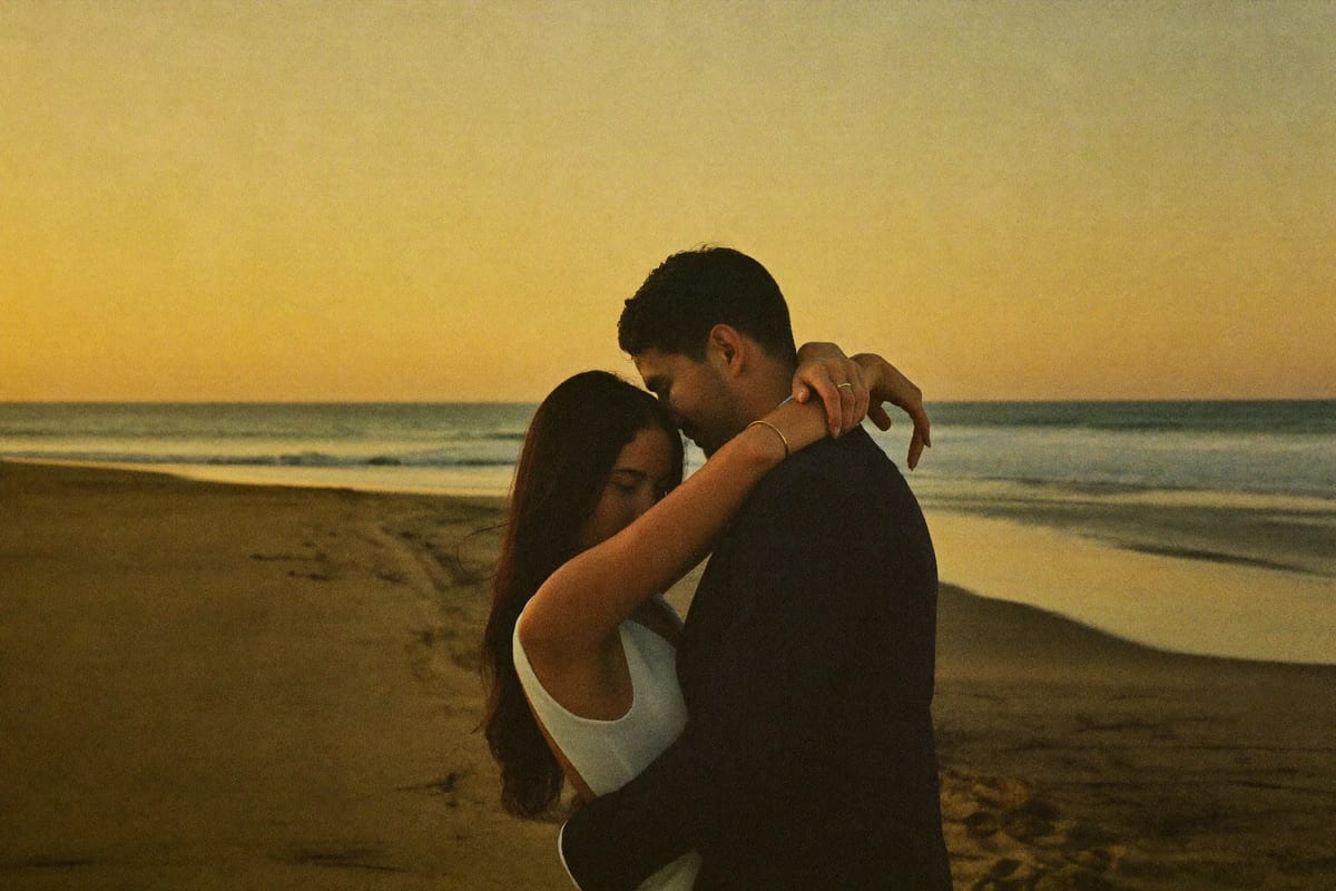 A bride and groom alone on a Mexican beach at sunset