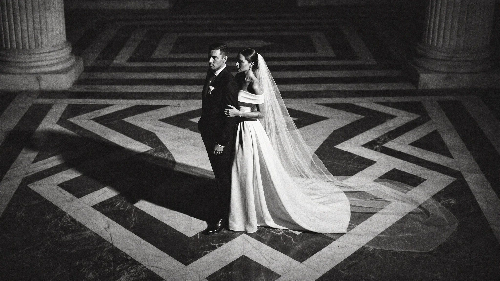 Couple centred on a graphic black and white marble floor